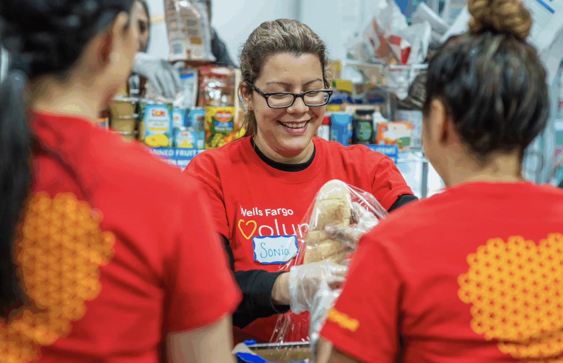 Wells Fargo volunteers packing food boxes for families Wells Fargo volunteers packing food boxes for families